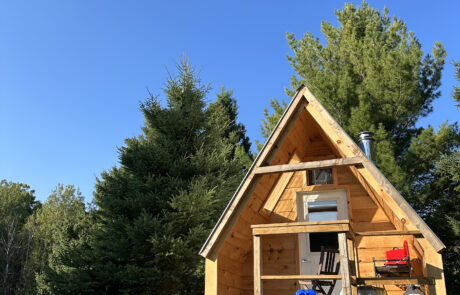Juniper cabin on a sunny day A-frame cabin in the countryside with a dreamy blue sky